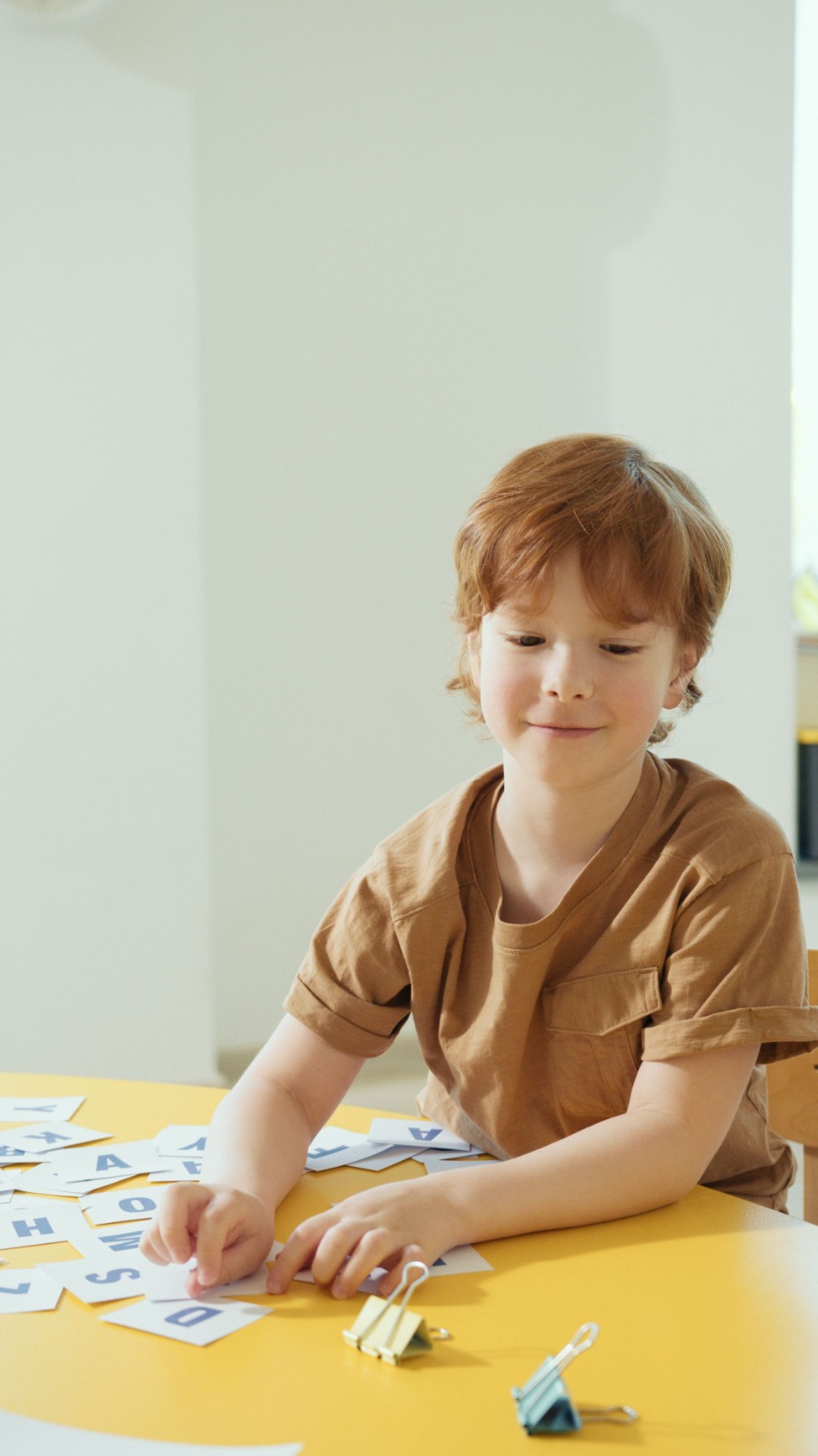 A child working with alphabet cards in an individualized learning session